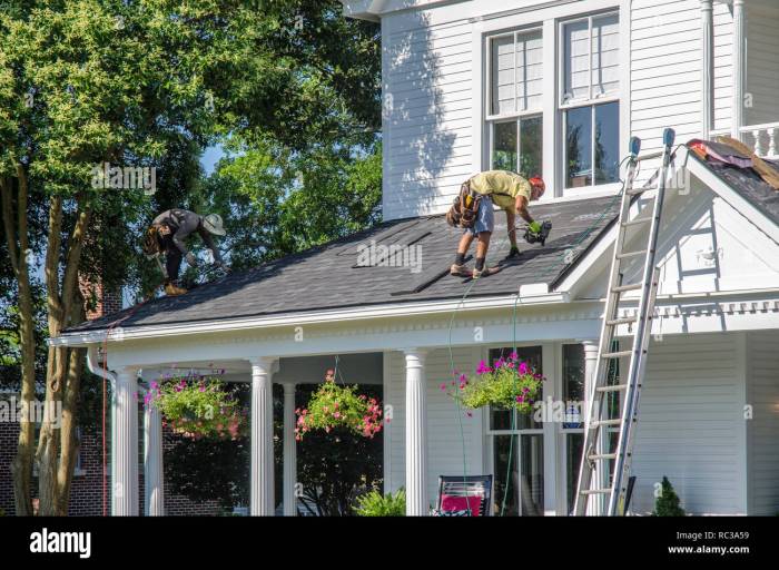 Roofing Contractors Replacing Damaged Roofs After a Hail Storm Stock ...
