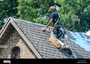 Roofing Contractors Replacing Damaged Roofs After a Hail Storm Stock ...