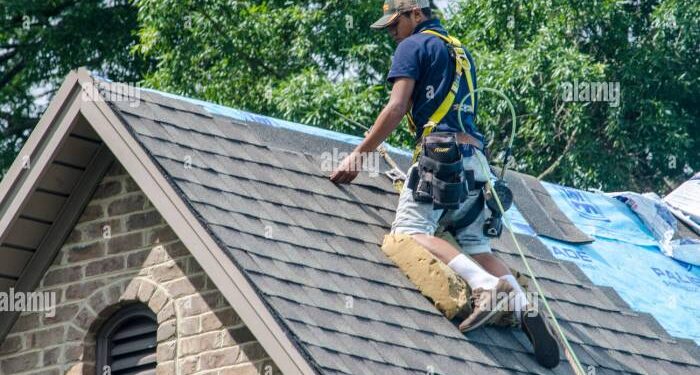Roofing Contractors Replacing Damaged Roofs After a Hail Storm Stock ...